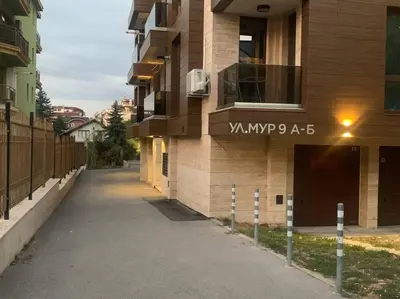 an empty street in front of a building at Brown Mur in Sofia