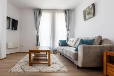 a living room with a couch and a coffee table at Light One Bed Flat next to the Ski Lift in Bansko