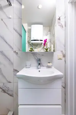 a white bathroom with a sink and a mirror at West Haven Apartments - 1BDs in Plovdiv Centre by Flat Mаnager in Plovdiv
