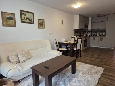 a living room with a couch and a table at Large One Bedroom with Terrace next to the Ski Lift in Bansko