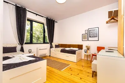 a bedroom with two beds and a desk at Chic and Charming 2BD Flat in the Heart of Plovdiv by Flat Mаnager in Plovdiv
