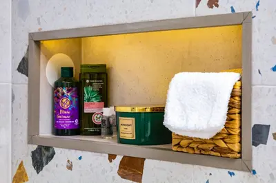 a shelf with towels and other bathroom items on it at Chic and Charming 2BD Flat in the Heart of Plovdiv by Flat Mаnager in Plovdiv