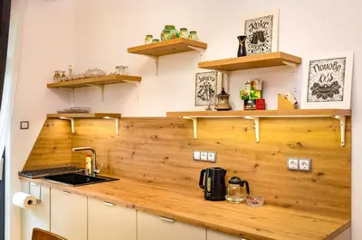 a kitchen with a wooden counter top and shelves at Chic and Charming 2BD Flat in the Heart of Plovdiv by Flat Mаnager in Plovdiv
