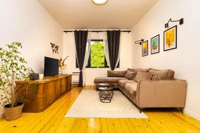 a living room with a couch and a tv at Chic and Charming 2BD Flat in the Heart of Plovdiv by Flat Mаnager in Plovdiv