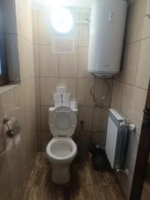 a small bathroom with a toilet and a window at Guest Rooms Didka in Koprivshtitsa