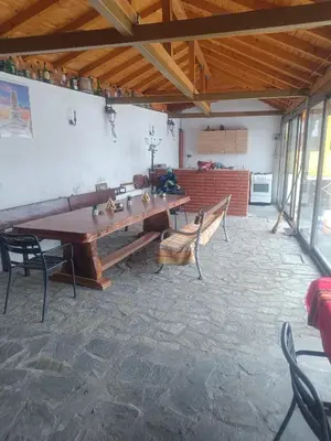 a large room with a wooden table and chairs at Guest Rooms Didka in Koprivshtitsa