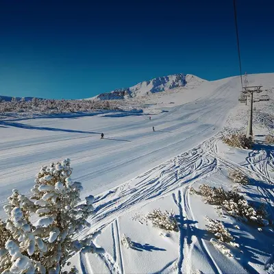 a snow covered slope with people skiing on a ski lift at Bansko Royal Towers - Studio 856 in Bansko