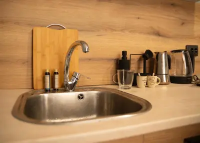 a kitchen counter with a stainless steel sink at The Cozy Corner in Sofia