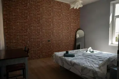 a bedroom with a brick wall and a bed at The Cozy Corner in Sofia