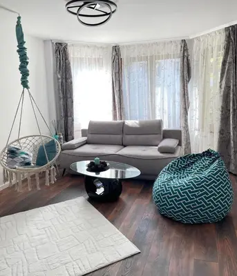 a living room with a couch and a table at Si apartments Free Parking in Sofia