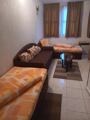 a living room with two beds and a couch at Хотел Марио in Melnik