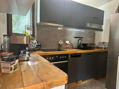 a kitchen with a wooden counter top and a sink at Villa Yarema Mountain Relax with Hot Jacuzzi & Sauna by BookVillaBG in Zheleznitsa