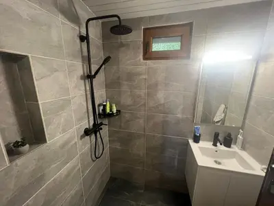 a bathroom with a shower and a sink at Villa Yarema Mountain Relax with Hot Jacuzzi & Sauna by BookVillaBG in Zheleznitsa