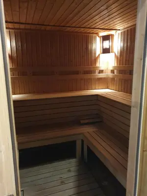a small wooden sauna with a light in it at Apartment ZAX B7 in Terra Complex in Bansko
