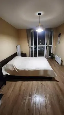 a bedroom with a large bed and a large window at Budget overnight- Struma highway in Pernik