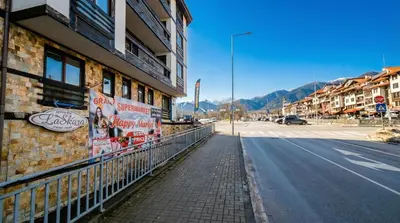 an empty street in front of a building at Mountain Paradise 4 - 1 Bedroom - Gondola, 100m away - Washer in Bansko