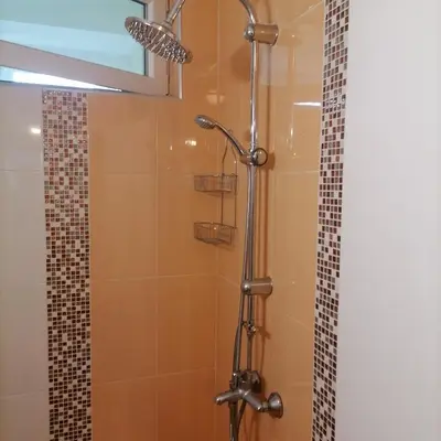 a bathroom with a shower with a glass door at M Art Apart in Sofia