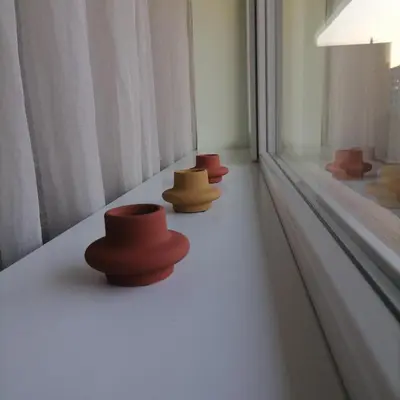 a row of hats sitting on a window sill at M Art Apart in Sofia