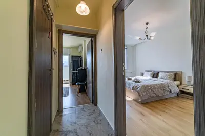 a bedroom with a bed and a living room at Nova #7 in Sofia