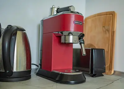 a red mixer sitting on a counter next to a microwave at Nova #7 in Sofia