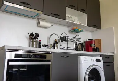 a kitchen with a dishwasher and a washing machine at Nova #7 in Sofia
