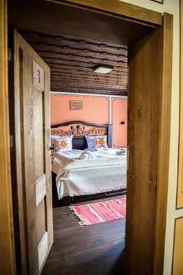 a small bedroom with a bed in a room at Къща ЕТНО in Koprivshtitsa