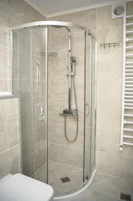 a shower with a glass door in a bathroom at Къща ЕТНО in Koprivshtitsa
