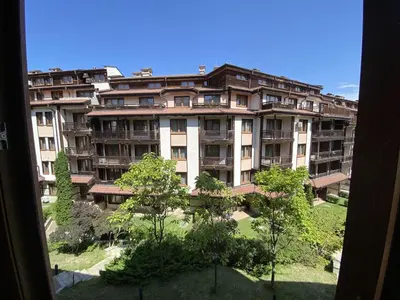 a large building with trees in front of it at Next to the Ski Lift Downtown Bansko in Bansko