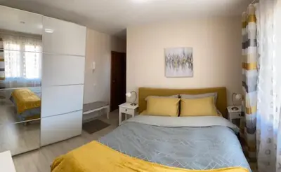 a bedroom with a bed and a glass wall at 2 bed 2 bath, 4 min walk to slope, Predela2, Bansko in Bansko