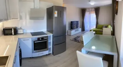 a kitchen with a counter top and a kitchen with a stove top oven at 2 bed 2 bath, 4 min walk to slope, Predela2, Bansko in Bansko