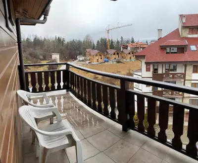 two white chairs sitting on a balcony with a view at 2 bed 2 bath, 4 min walk to slope, Predela2, Bansko in Bansko