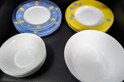 a group of white plates and yellow and blue plates at Maryland Apartment incl Private Garage in Sofia