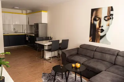 a living room with a couch and a kitchen at Maryland Apartment incl Private Garage in Sofia