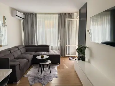 a living room with a couch and a table at Maryland Apartment incl Private Garage in Sofia