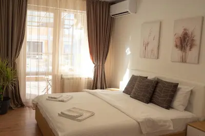 a bedroom with a bed with towels on it at Maryland Apartment incl Private Garage in Sofia
