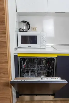 a microwave oven sitting on top of a dishwasher at Maryland Apartment incl Private Garage in Sofia