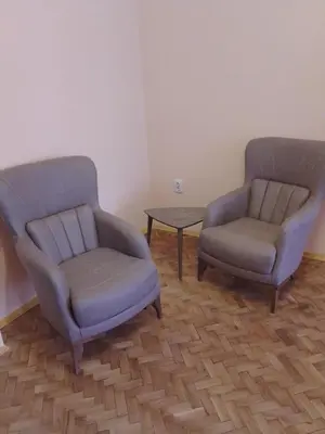 two chairs and a table in a room at Apartment Lozenetz in Sofia