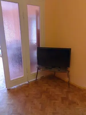 a living room with a flat screen tv and two windows at Apartment Lozenetz in Sofia
