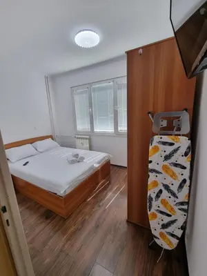 a small bedroom with a bed and a closet at Apartment's Ortakchiev 2 in Sofia