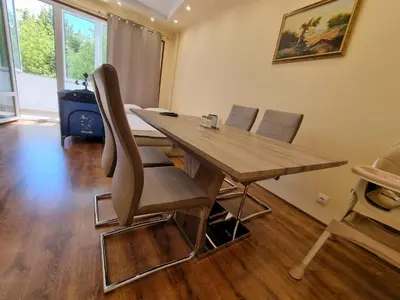 a dining room with a wooden table and chairs at Apartment's Ortakchiev 2 in Sofia