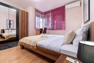a bedroom with a bed with a laptop on it at Comfortable 2BR Urban Getaway in City Center by Flat Mаnager in Plovdiv