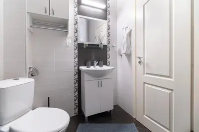 a white bathroom with a toilet and a sink at Comfortable 2BR Urban Getaway in City Center by Flat Mаnager in Plovdiv