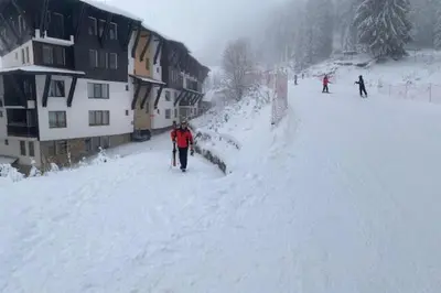 a group of people skiing down a snow covered slope at Ski-in Ski-out Studio, Grand Monastery, Pamporovo in Pamporovo