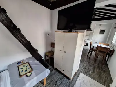 a living room with a tv on top of a cabinet at Musala 1 Bed & Breakfast in Kyustendil
