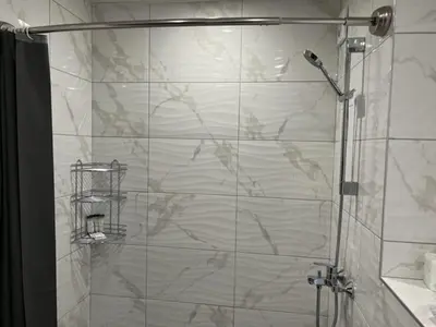 a shower with a glass door in a bathroom at Апартамент Комфорт, близо до Летището in Sofia