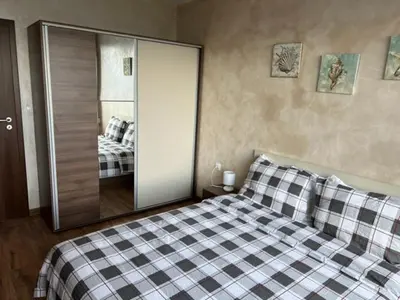 a bedroom with a bed with a sliding glass door at Апартамент Комфорт, близо до Летището in Sofia