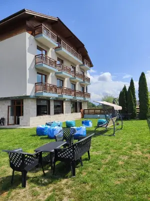 a apartment building with a picnic table and a playground at Shekerdejiiski guest house bansko in Bansko