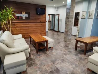 a living room with a couch and a table at Shekerdejiiski guest house bansko in Bansko