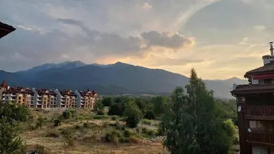 a group of buildings with mountains in the background at Belvedere Holiday Club - Mountain View in Bansko