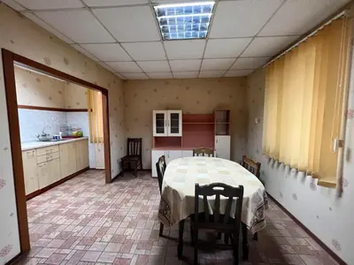 a kitchen with a table and chairs in a room at Почивна база Пиринпласт in Gotse Delchev